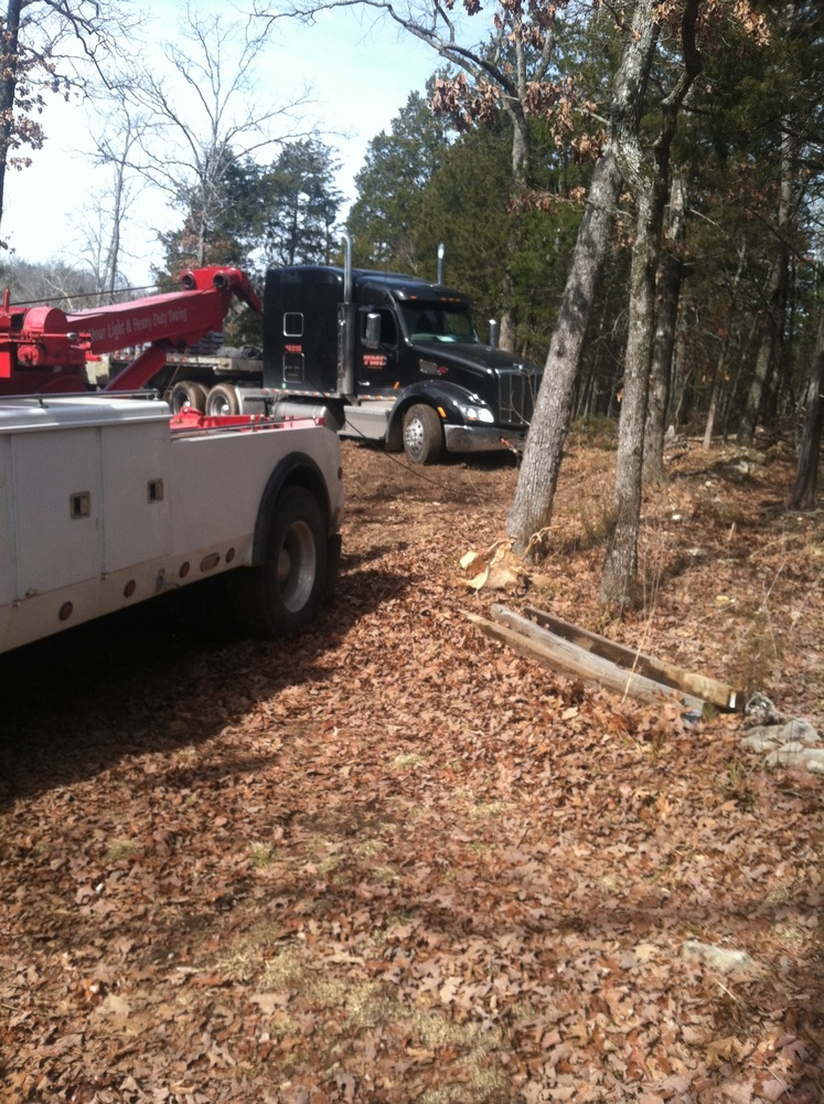 Towing semi-truck out of the woods