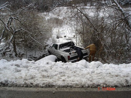 Truck in snowy ditch to be recovered