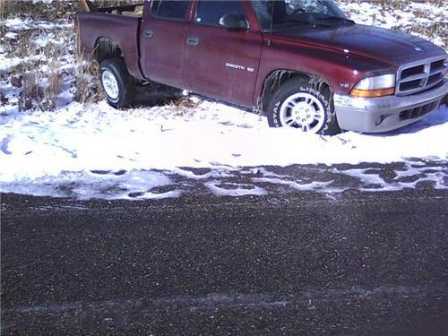 Truck in snowy ditch to be recovered