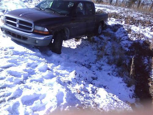 Truck in snowy ditch to be recovered