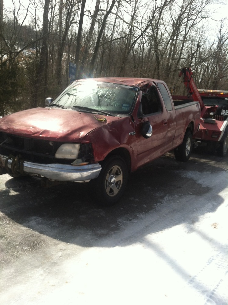 Truck after being recovered flipped in a snowy ditch