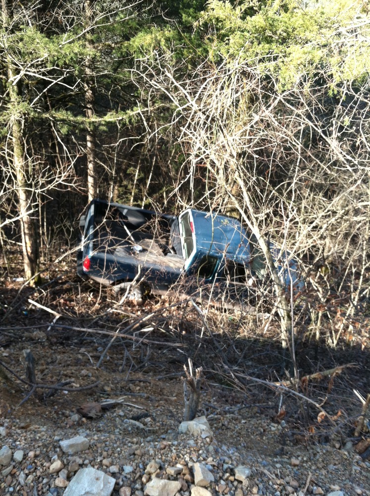 Truck gone off the road and down a hill into the woods