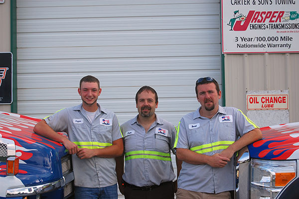 Jason, Daniel, and Kegan with 2 of our trucks
